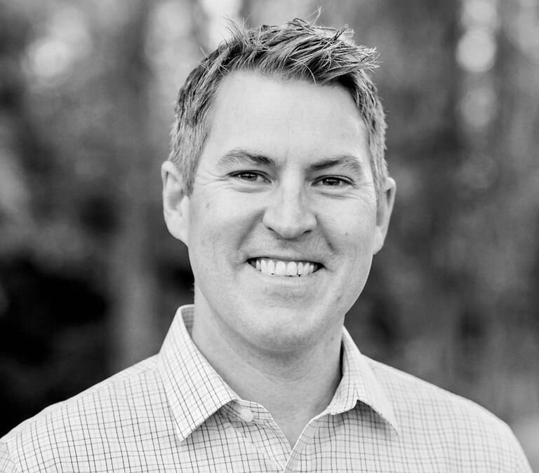 Headshot of pastor Ryan Sutherland, smiling at the camera